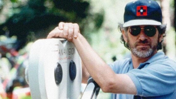 Steven Spielberg directing a movie on set with a camera crew behind him