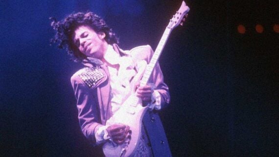 Prince performing an emotional rock ballad on stage with dramatic lights