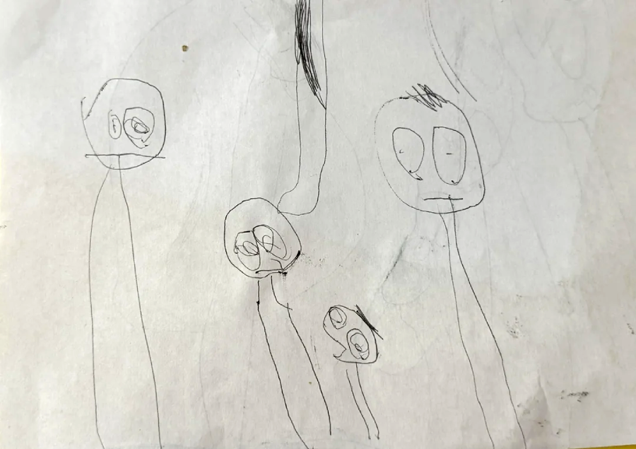 A child's pencil drawing of four stick-figure people with large round heads, wide eyes, and simple lines for bodies and facial features on a white, slightly smudged paper.