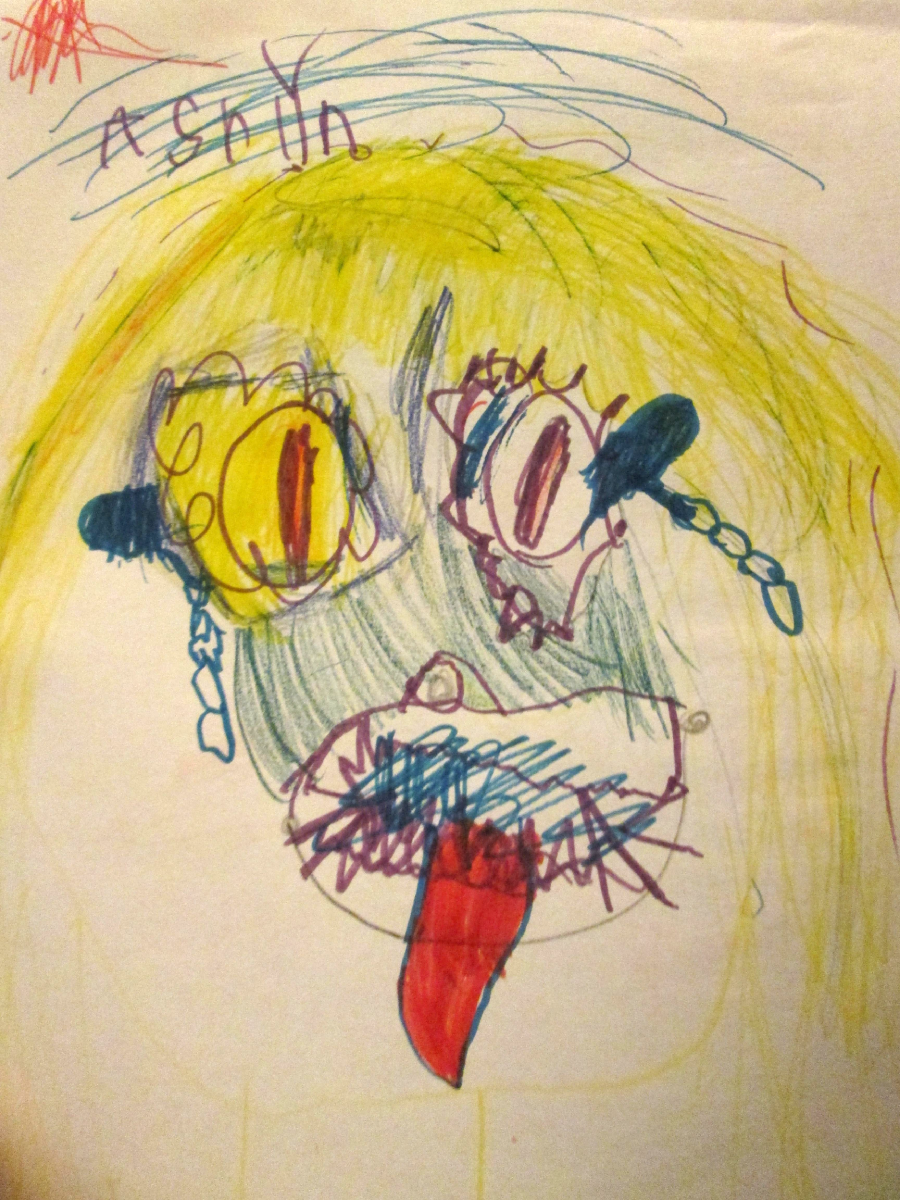 A colorful, childlike drawing of a face with yellow and green hair, large uneven eyes, blue and red scribbled mouth, and a red tongue sticking out. "ASHLYN" is written at the top in purple crayon.