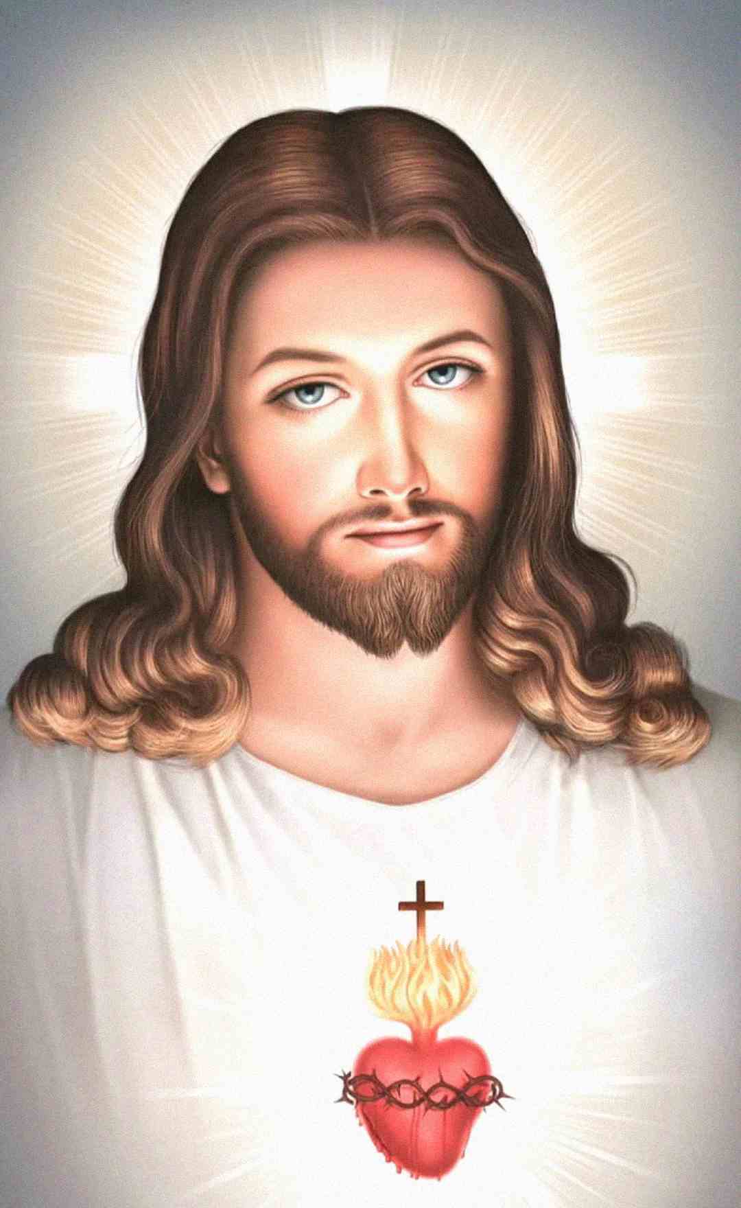 Illustration of Jesus with long brown hair and a beard, wearing a white robe. A glowing Sacred Heart with a cross, flames, and crown of thorns is depicted on his chest, with radiant light surrounding his head.