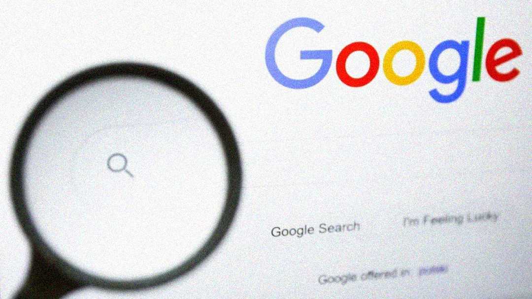 A magnifying glass hovers over the Google search homepage, focusing on the search box and search icon, with the colorful Google logo visible at the top.