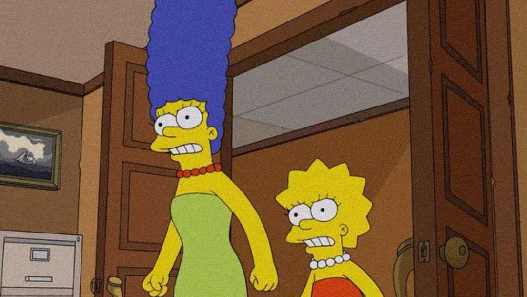 Marge and Lisa Simpson from "The Simpsons" look angry as they stand in a room with open double doors, both clenching their fists. Marge wears her green dress and Lisa her orange dress with a pearl necklace.