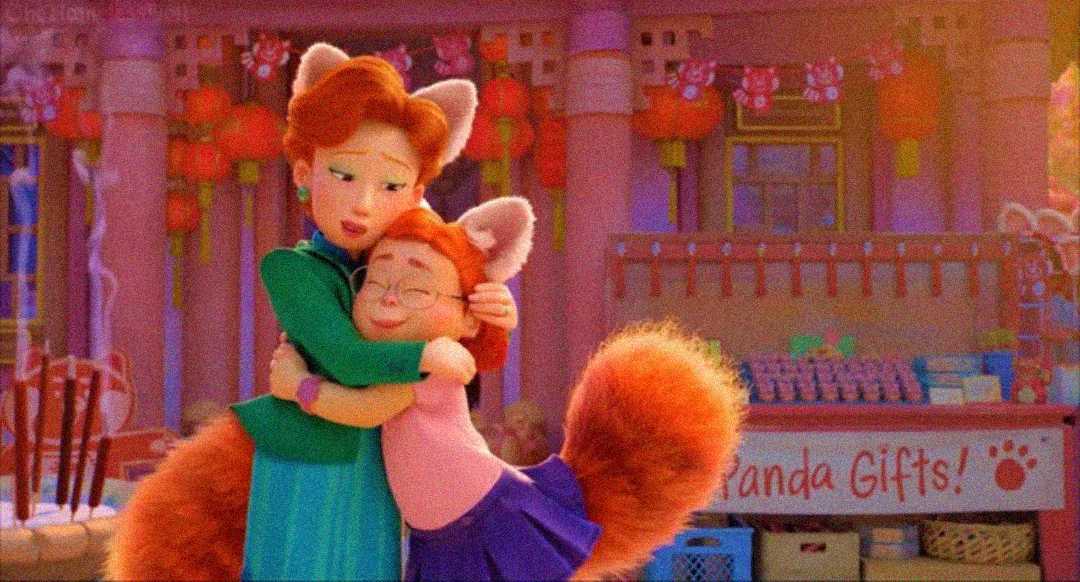 Two animated characters with red hair, fox ears, and large fluffy tails hug each other in a gift shop decorated with red lanterns. The sign behind them reads "Panda Gifts!" in playful lettering.