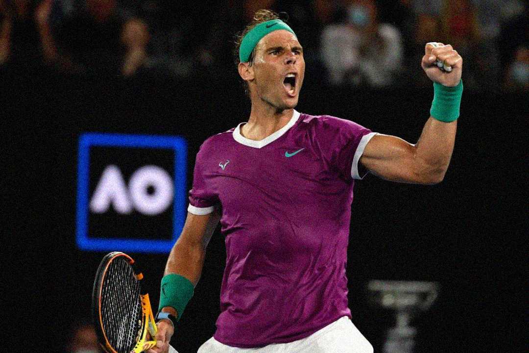 A male tennis player in a purple shirt and green headband pumps his fist and shouts in celebration on a tennis court, holding a racket. The letters "AO" are visible in the background.
