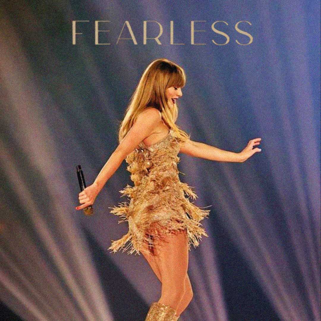 A woman in a gold fringed dress and boots holds a microphone on stage, walking confidently under colorful lights with the word "FEARLESS" above her.