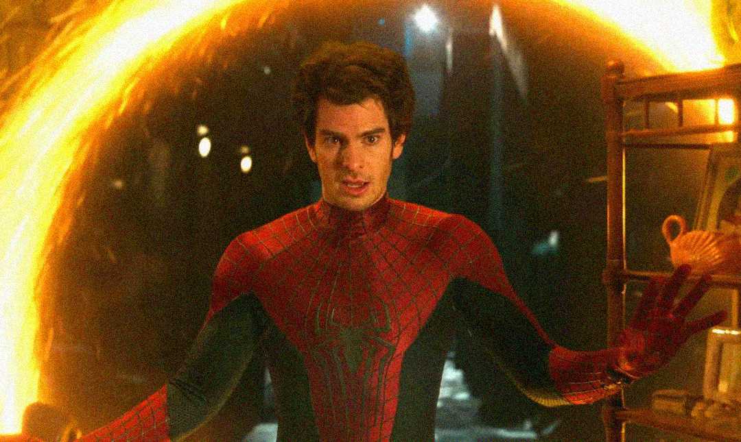 Andrew Garfield as Spider-Man stands in front of a glowing orange portal, reaching his hands out.