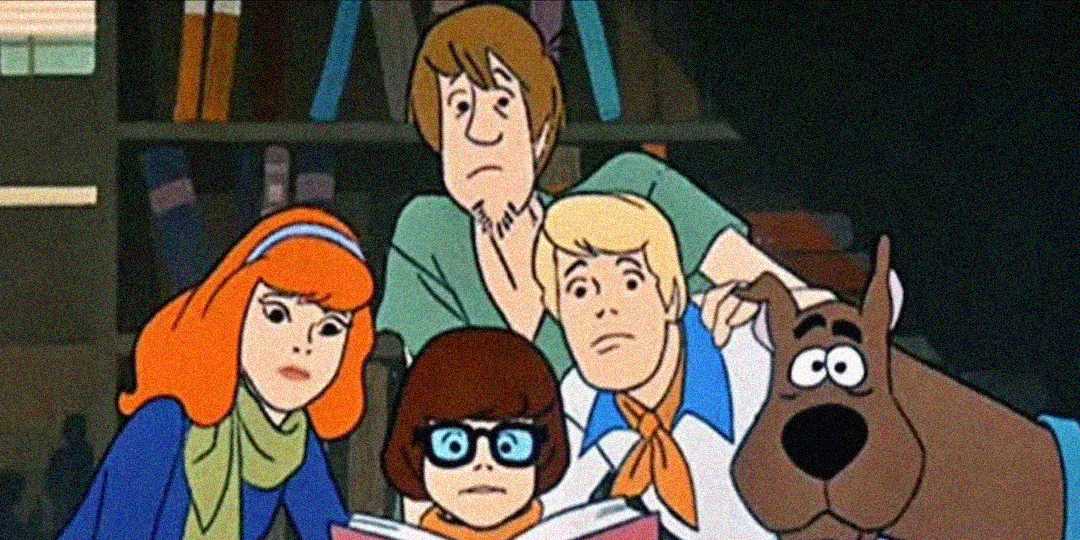 Five animated characters, including a dog, are closely gathered and looking intently at an open book, appearing curious or concerned. The background shows shelves with books.
