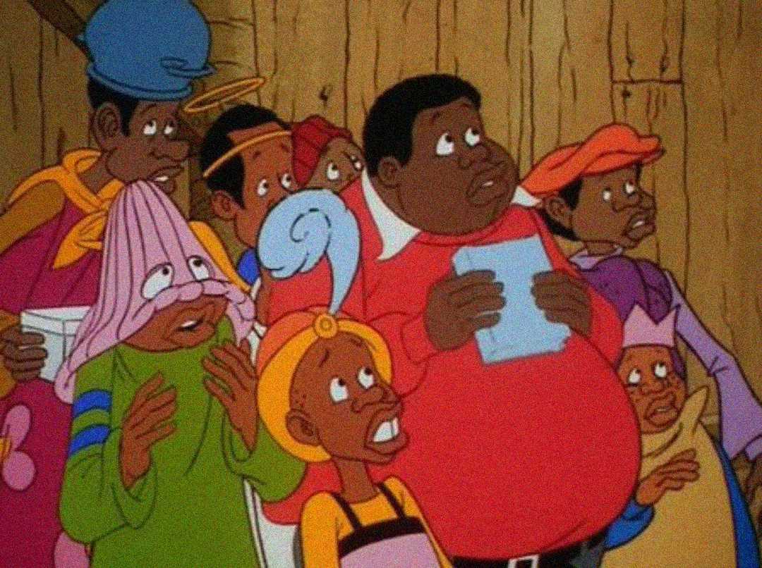 A group of animated characters in colorful, quirky costumes look surprised and concerned inside a wooden building. One character holds a piece of paper, and another wears a towel over their head with eye holes cut out.