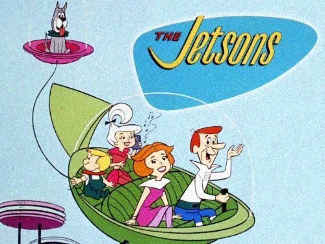 Animated image of The Jetsons family in a green flying car with clear domes. Their dog Astro floats in a separate bubble pod above them. The Jetsons logo appears on a blue background in the upper right.