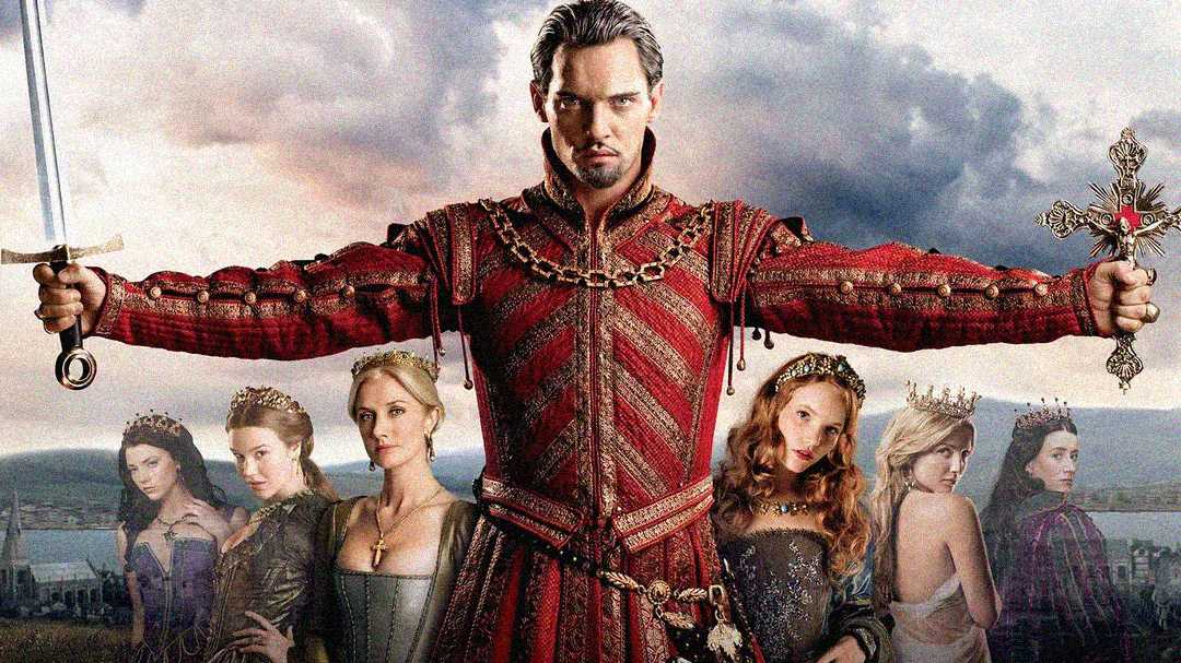 A man in elaborate red royal clothing stands with arms outstretched, holding a sword and a cross. Six women in regal dresses and crowns stand behind him, all against a cloudy sky backdrop.