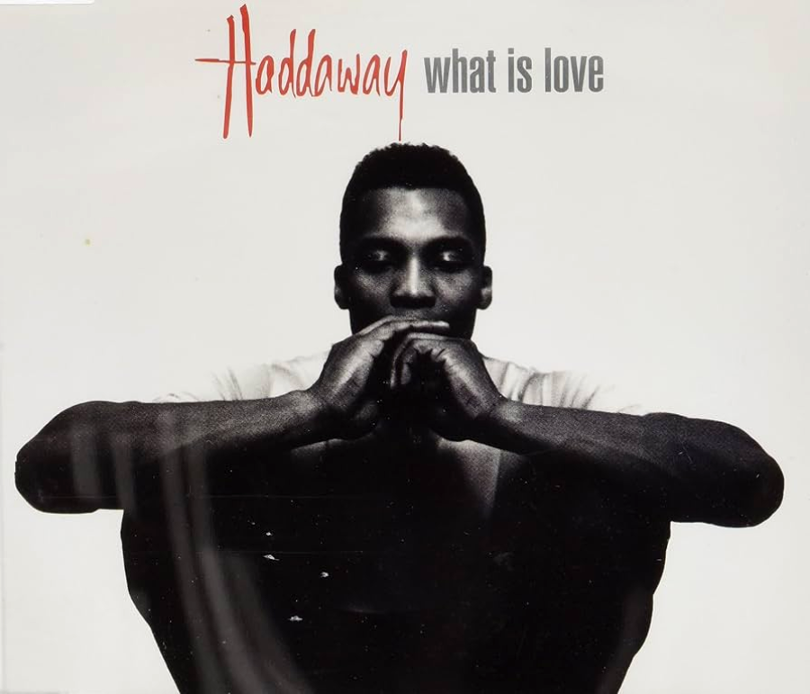 Black and white album cover featuring a man sitting with his arms resting on his knees, hands near his face. The text above reads "Haddaway what is love" in red and gray letters.