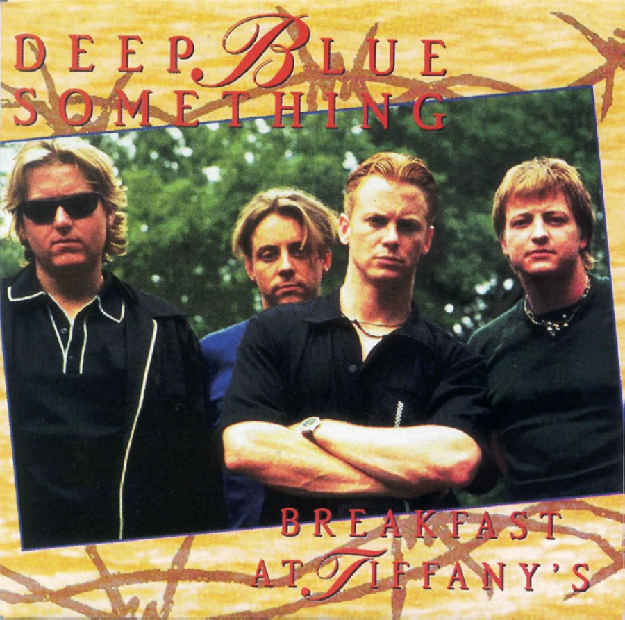 Four men stand together outdoors, looking serious, on the album cover for Deep Blue Something’s "Breakfast at Tiffany’s." The band’s name and album title are displayed in large red and blue letters.