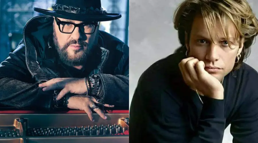Two men side by side; the left man wears glasses, a hat, and dark clothes, resting his hands on a piano, while the right man with light hair leans his head on his hand, wearing a black shirt and an earring.
