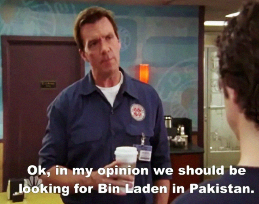 A man in a blue work uniform holding a coffee cup speaks to someone off-screen. Text on the image reads: "Ok, in my opinion we should be looking for Bin Laden in Pakistan.