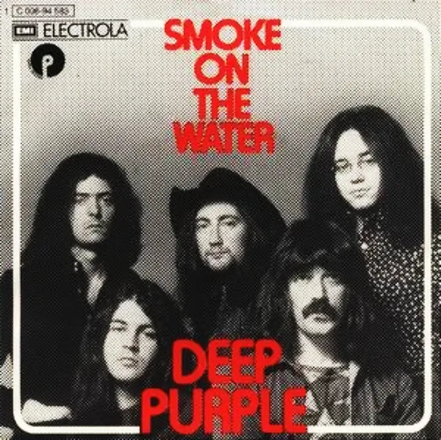 Black and white photo of five men with long hair, some with facial hair, posing for the cover of Deep Purple’s single “Smoke on the Water.” Bold red text shows the song and band name above and below the group.