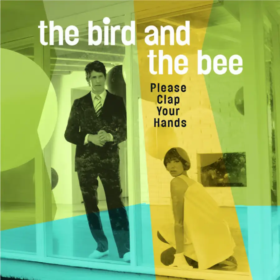 Album cover for "Please Clap Your Hands" by The Bird and The Bee, featuring a man in a suit standing behind a woman in a white dress kneeling on the floor, with colorful translucent overlays and modern text.