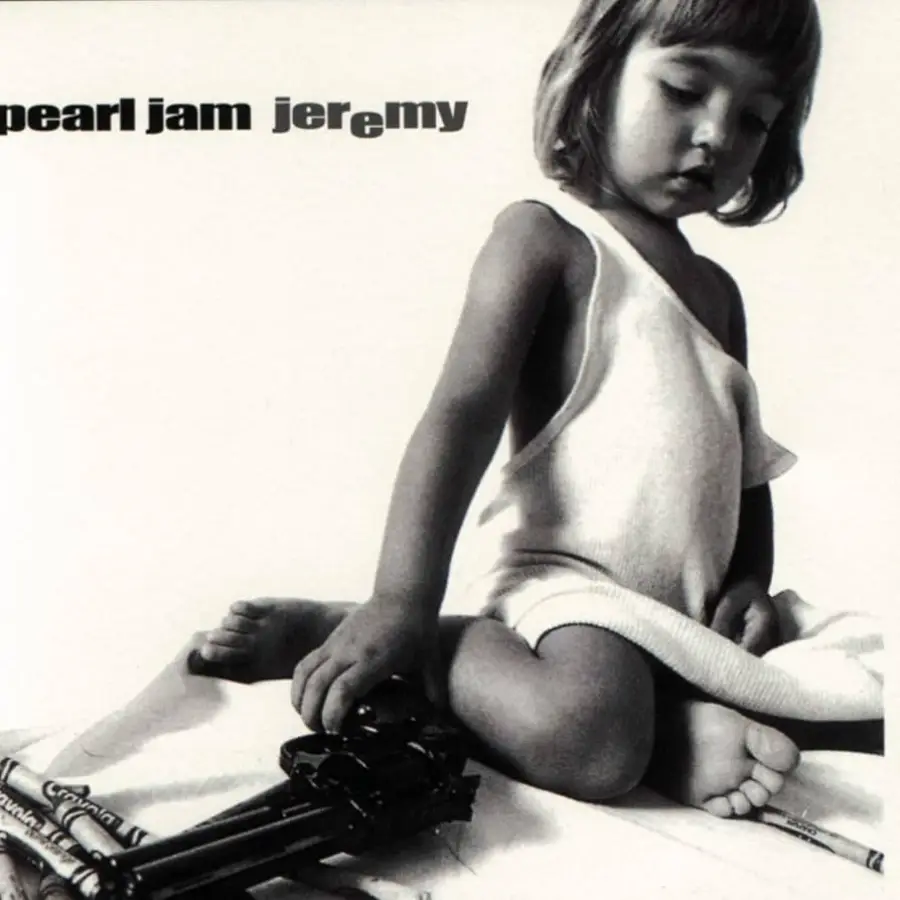 A young child in a white dress sits on the floor, looking down, with one hand resting on a toy gun. The image is in black and white. Text at the top left reads "pearl jam jeremy.