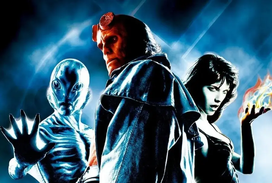 Three characters pose against a blue, smoky background: an amphibious humanoid with webbed hand raised, a red-skinned figure with a stone hand and goggles, and a woman in black with fire swirling around her hand.
