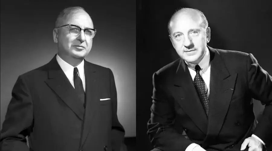 Two men in dark suits and ties pose for black and white portraits against plain backgrounds. Both have short hair; one wears glasses and stands with arms at his sides, while the other sits with one arm resting on a surface.