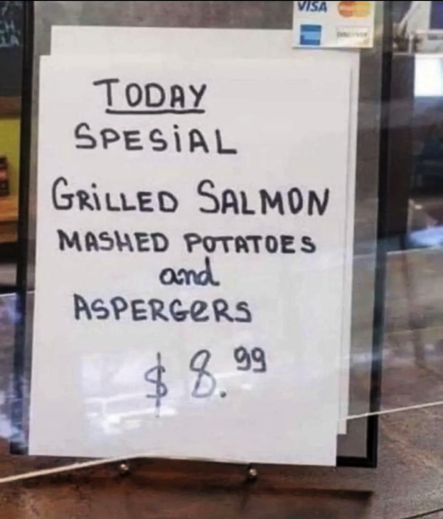 A handwritten sign reads: "Today Special: Grilled Salmon, Mashed Potatoes and Aspergers $8.99." The word "Aspergers" appears to be a misspelling of "asparagus.
