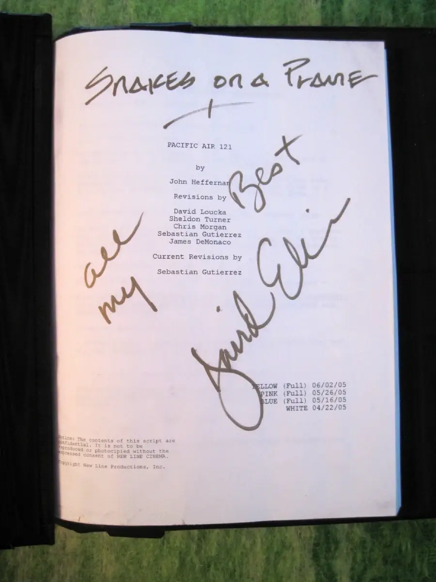 A movie script titled “Pacific Air 121” with “Snakes on a Plane” handwritten at the top, and “all my best” followed by a signature written in large marker across the page.
