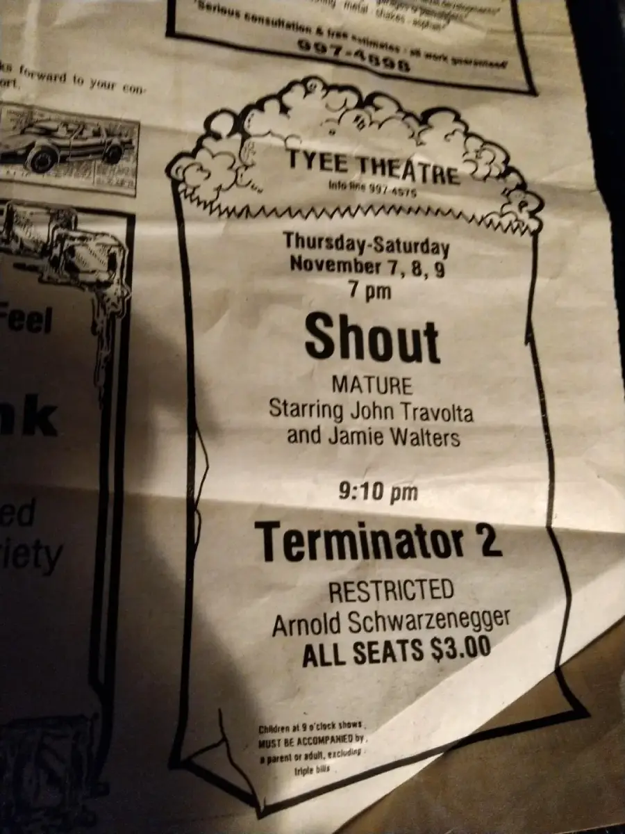 A newspaper ad for Tyee Theatre shows movie listings: "Shout" at 7 pm, starring John Travolta and Jamie Walters, rated Mature; and "Terminator 2" at 9:10 pm, starring Arnold Schwarzenegger, rated Restricted. All seats $3.