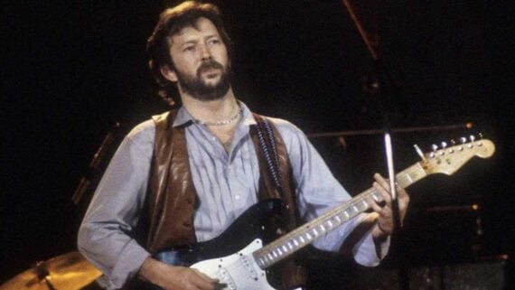 Eric Clapton performing on stage, representing artists who transformed personal struggles into unforgettable songs.