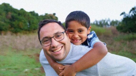 Child hugging their dad in a heartfelt family moment at home.
