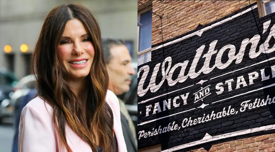 A woman with long brown hair smiles outdoors, standing beside a mural on a brick wall that reads "Walton's Fancy and Staple: Flourishable, Cherishable, Fetishable.