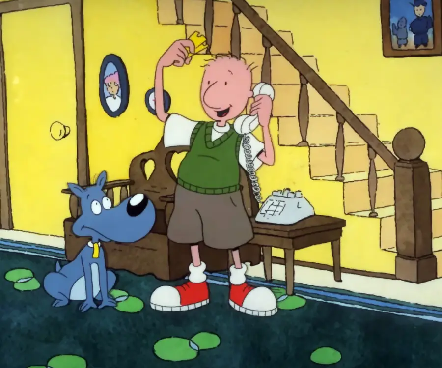 A cartoon boy stands by a staircase, smiling while talking on a corded phone and holding a piece of paper. A blue dog sits next to him on a rug with green spots in a cozy, yellow living room.