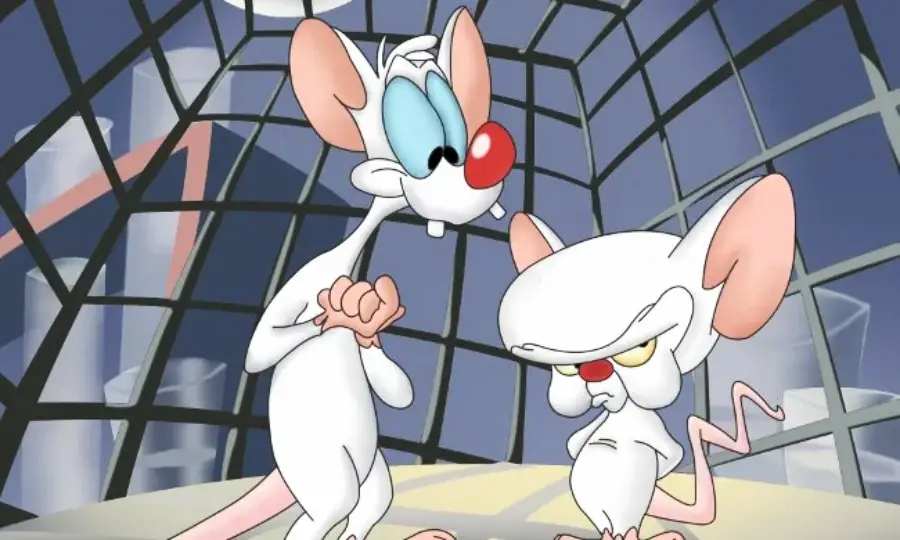 Two cartoon laboratory mice stand in a room with a glass wall; one is tall and cheerful with big blue eyes, while the other is shorter, frowning, and has a large head and pink ears.