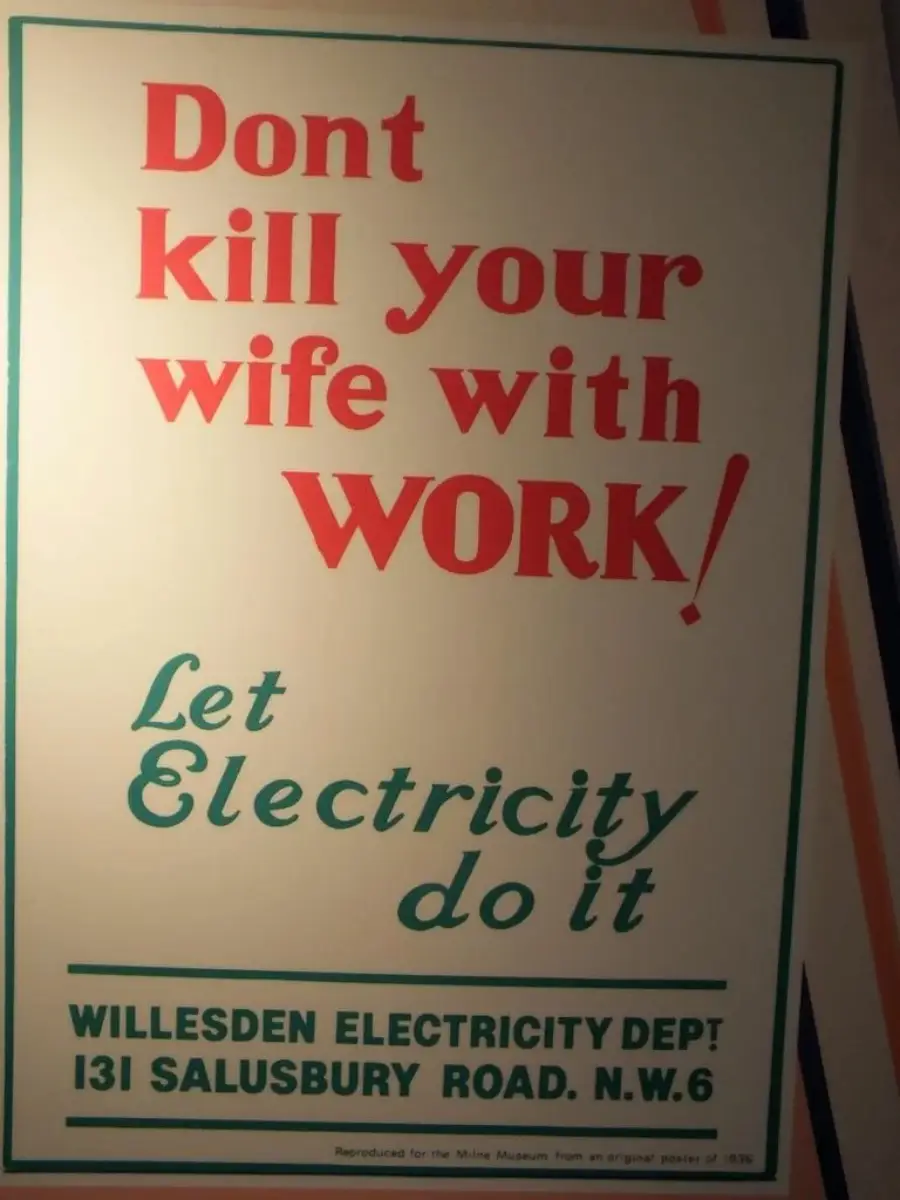 A vintage poster reads: "Don't kill your wife with work! Let electricity do it." Below is contact info for Willesden Electricity Dept, 131 Salusbury Road, N.W.6 in green text on a cream background.