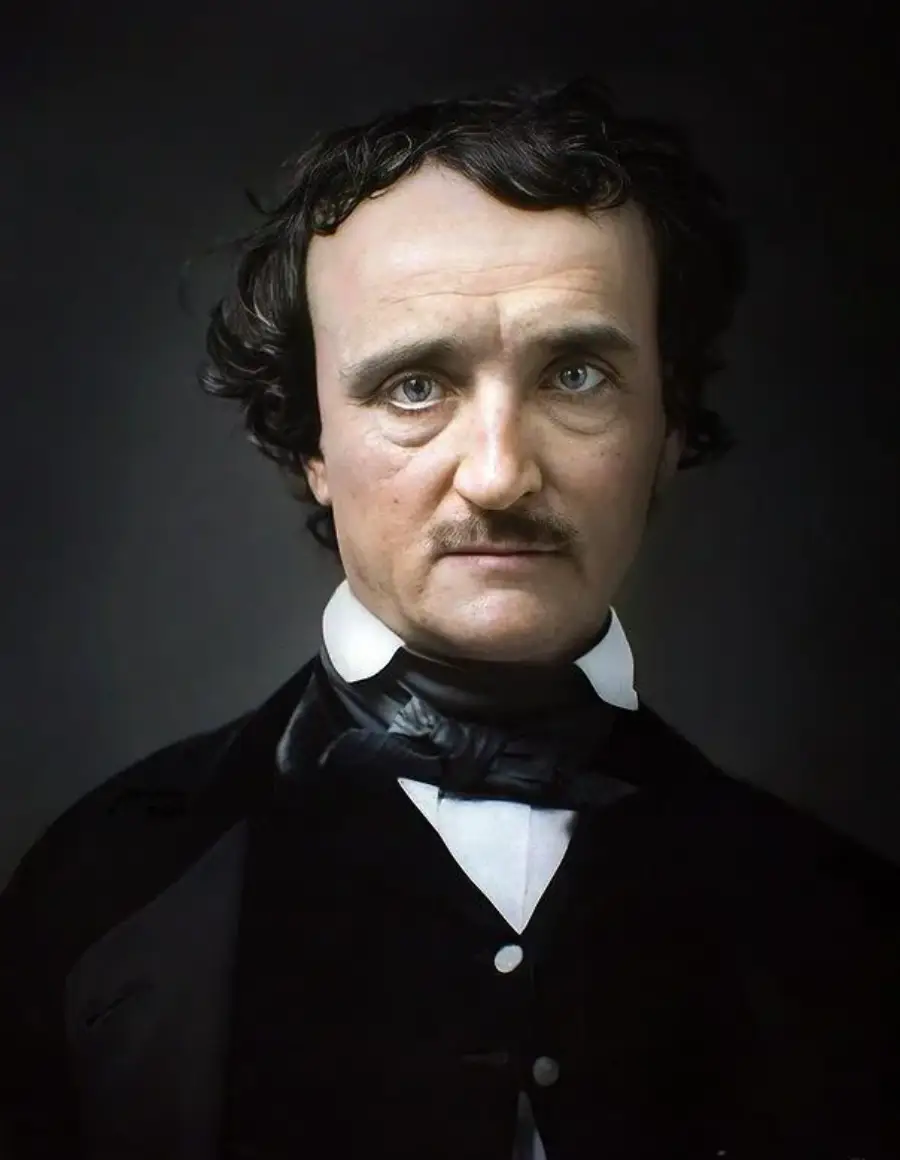 A man with pale skin, dark hair, and a mustache wears a black coat, white shirt, and black cravat, looking directly at the camera with a serious expression against a dark background.
