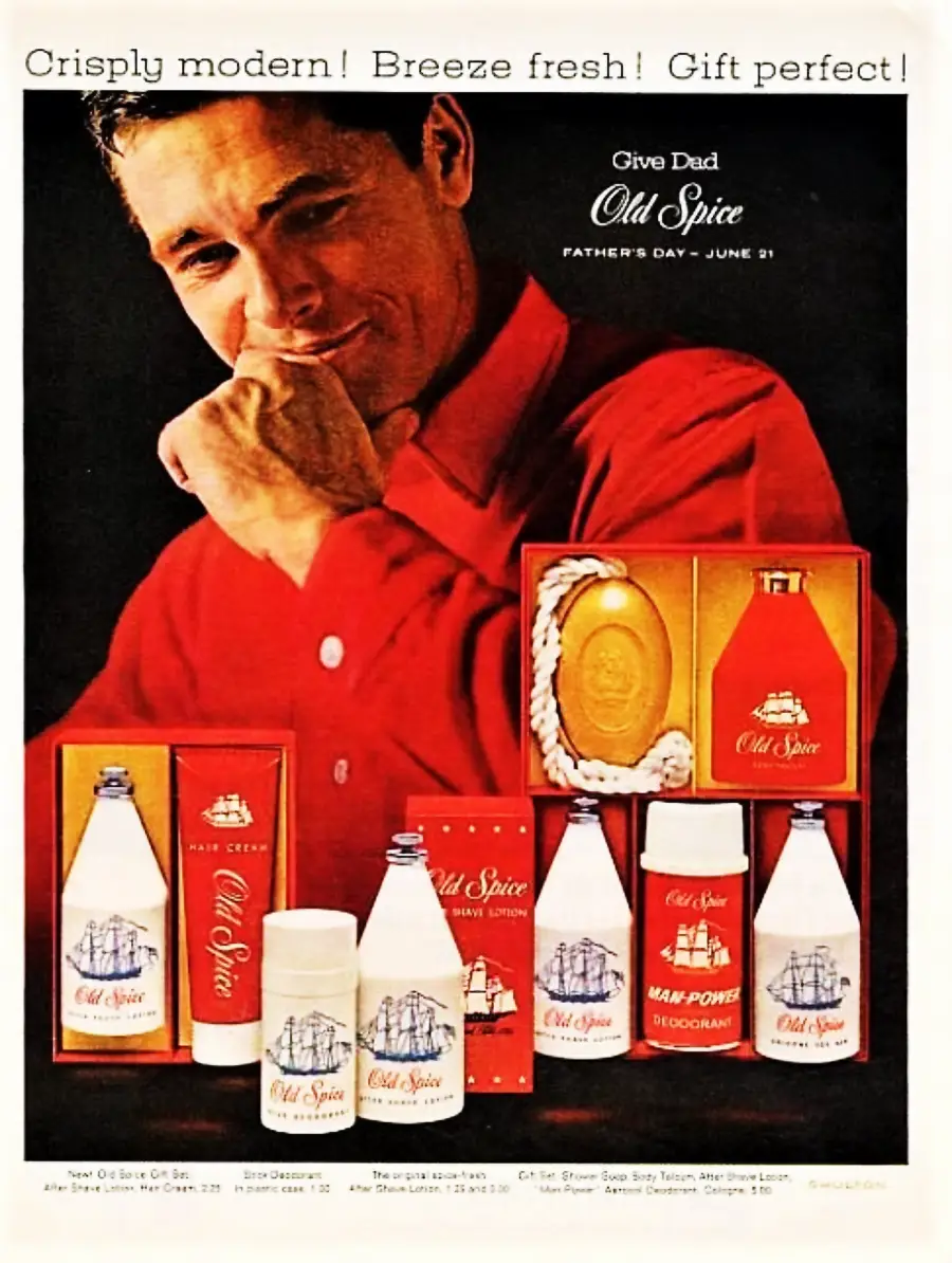 A smiling man in a red shirt poses with his hand near his face, surrounded by Old Spice gift sets including after shave, soap, and deodorant. The ad reads, "Give Dad Old Spice. Father's Day — June 21.