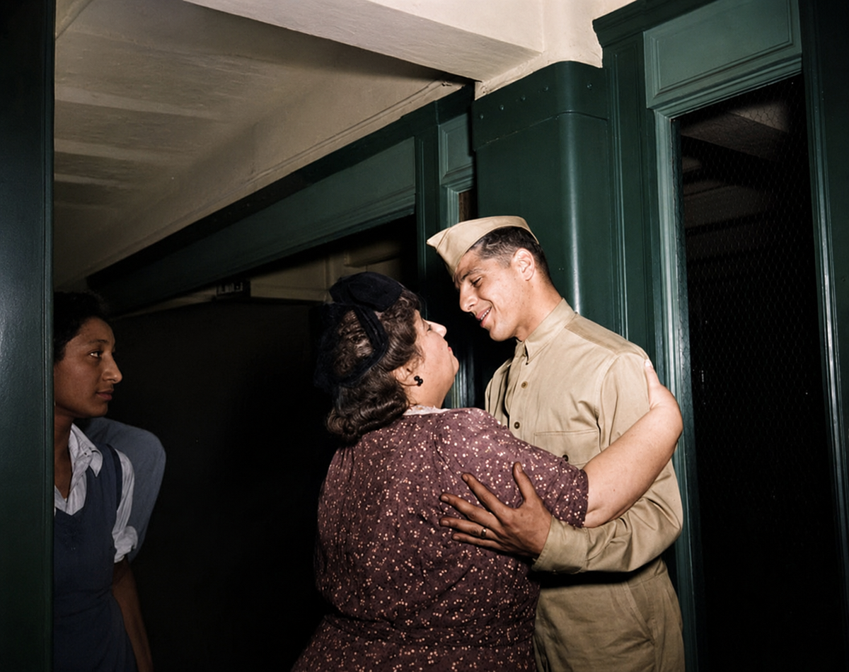 A woman joyfully embraces a smiling man in military uniform near a doorway, while another woman watches nearby. The scene appears to be a reunion, likely set in the mid-20th century.