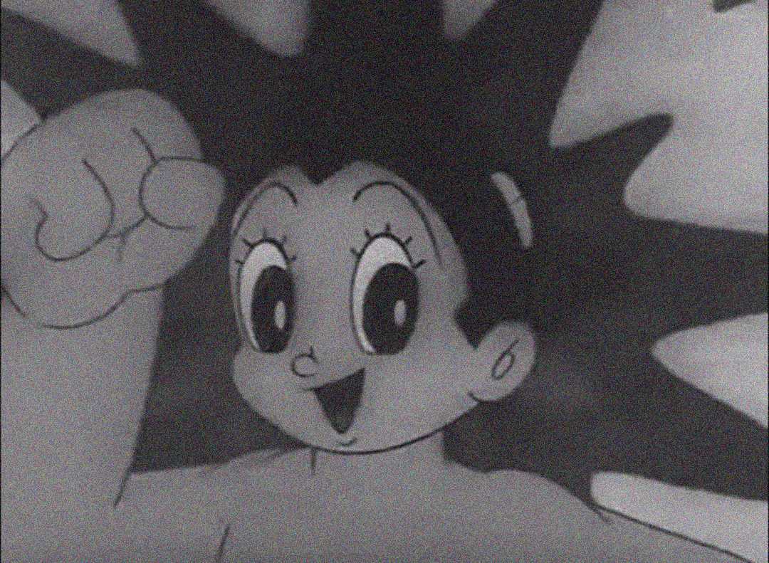 Black-and-white drawing of a cartoon character with spiky hair, large expressive eyes, and a smiling face, raising one fist enthusiastically.