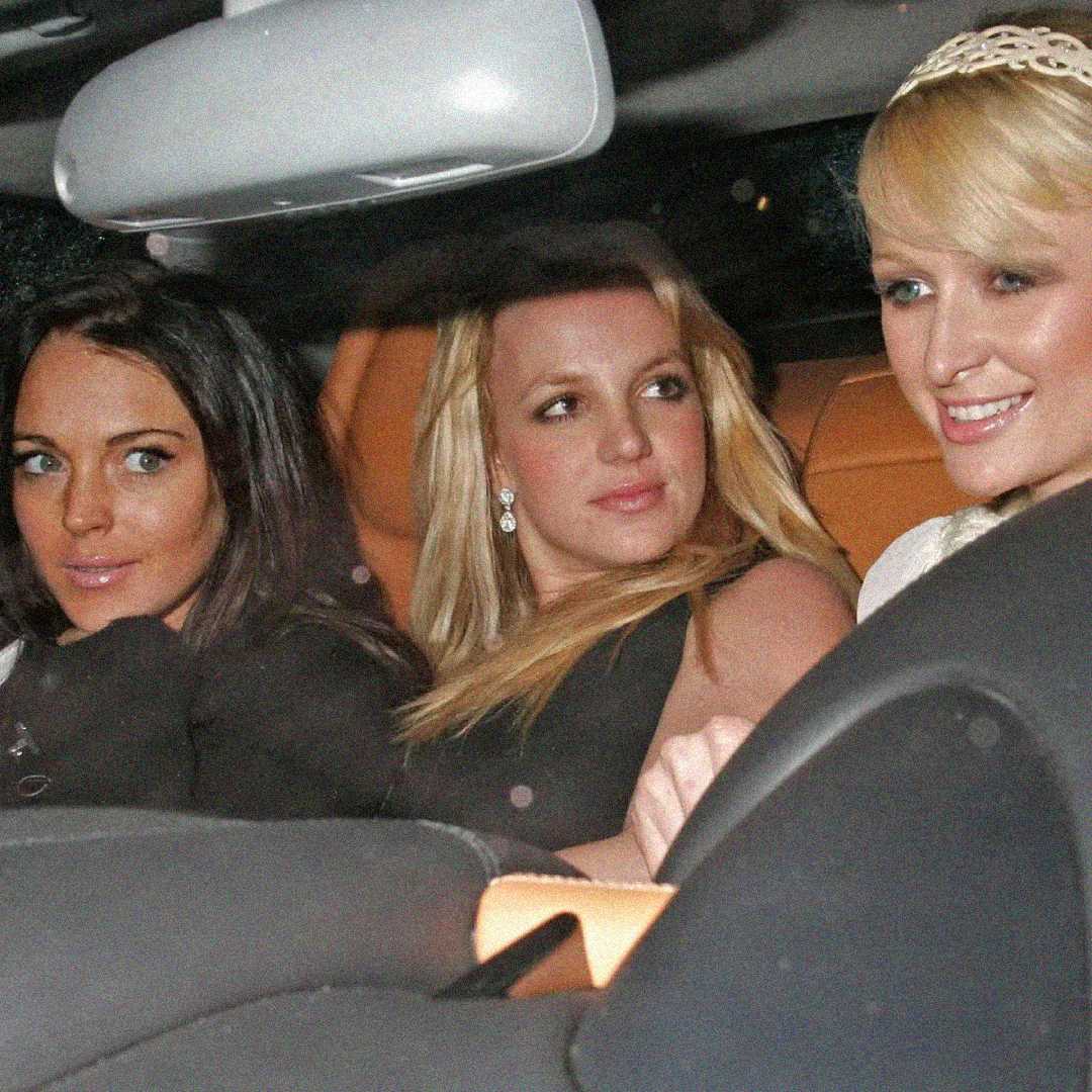Three women sit together in the front seats of a car at night, dressed up for an event. They appear to be smiling and looking out of the car, with the interior softly lit.