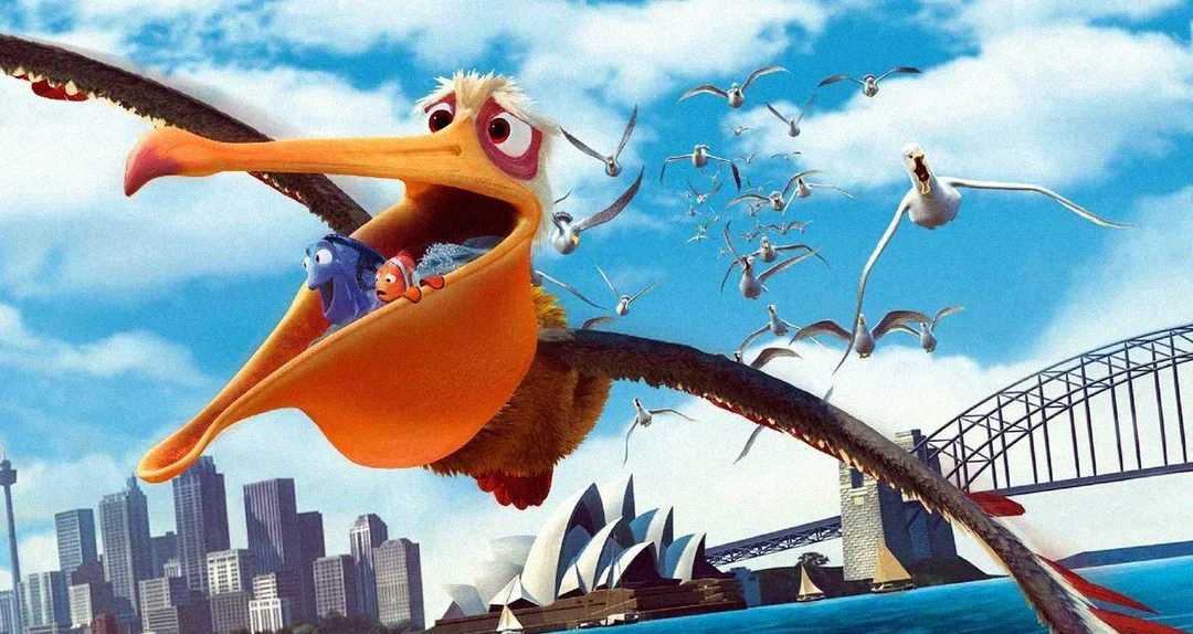 A cartoon pelican flies over Sydney with Dory and Marlin, animated fish characters, inside its beak. Other birds follow behind, and the Sydney Opera House and Harbour Bridge are visible below.