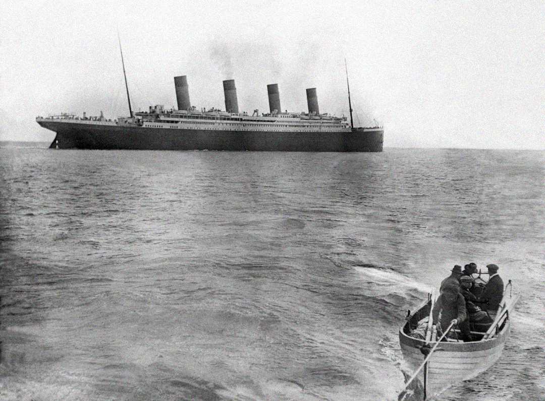 A historic black-and-white photo shows the Titanic at sea in the background, with a small lifeboat carrying several passengers rowing away in the foreground.
