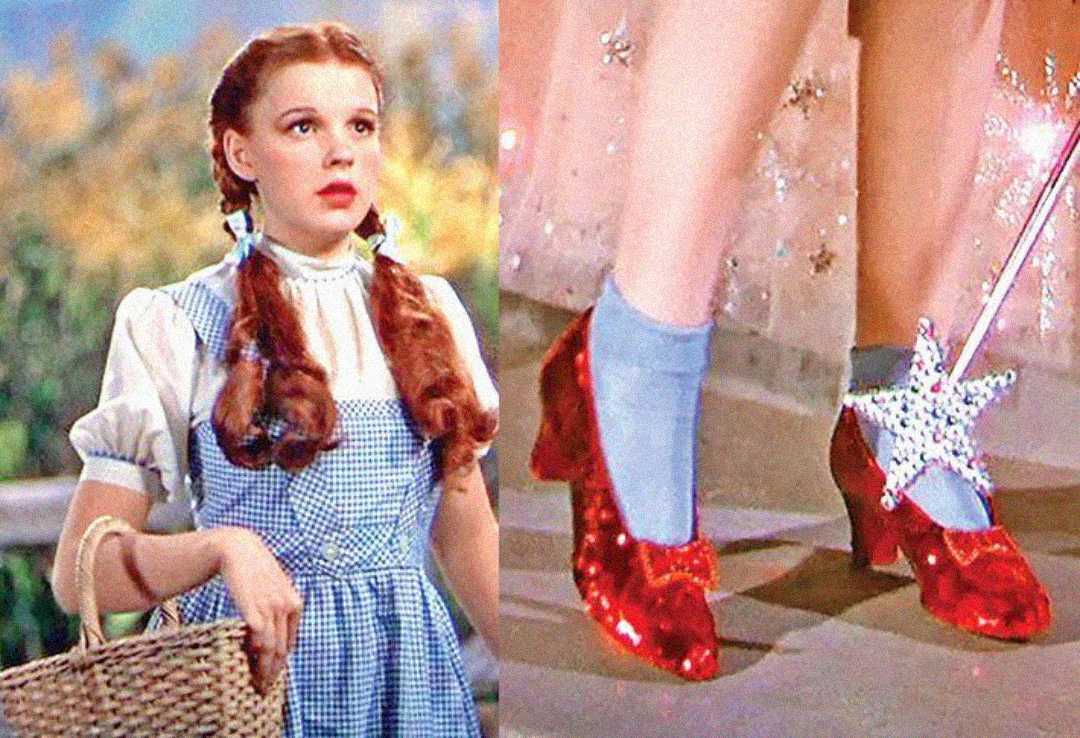A girl with braided hair in a blue gingham dress holds a basket. Next to her, a close-up shows her feet in sparkling red shoes, touched by a star-tipped wand.