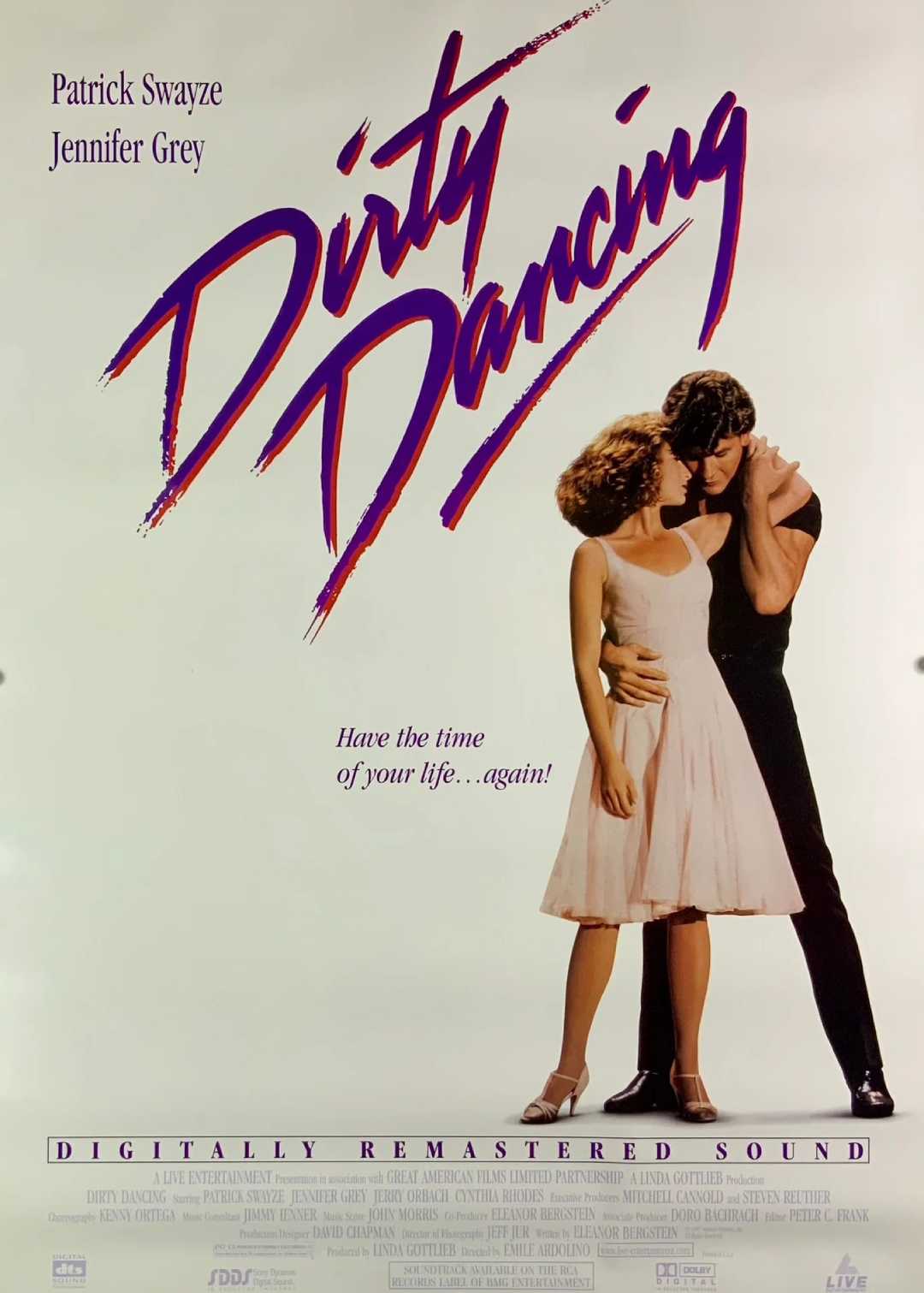 Movie poster for "Dirty Dancing" shows a man and woman dancing closely. The title is in large pink script. Actors Patrick Swayze and Jennifer Grey are listed above. Tagline: "Have the time of your life... again!