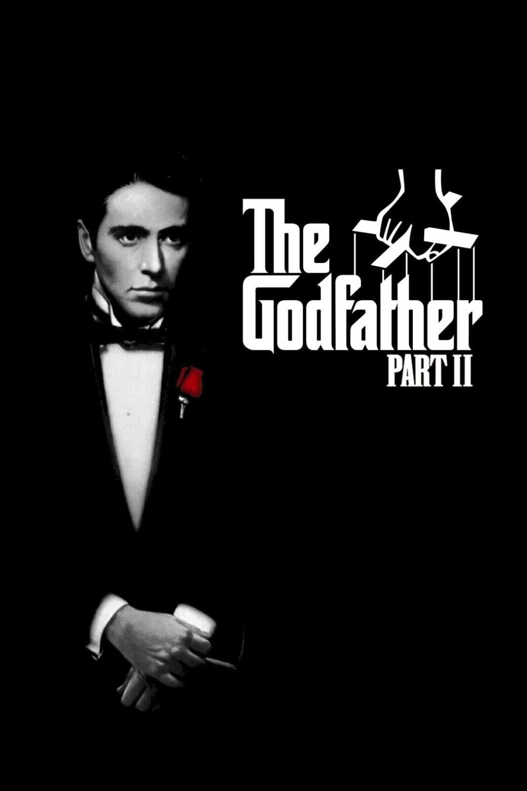 A man in a black tuxedo with a red rose stands against a black background next to white text that reads "The Godfather Part II," with a hand manipulating puppet strings above the title.