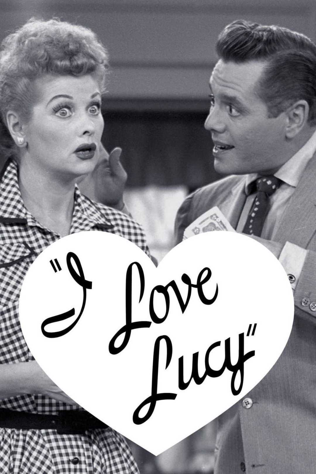 Black-and-white image of a surprised woman and a man talking, with a large white heart in the center displaying the text “I Love Lucy” in cursive.