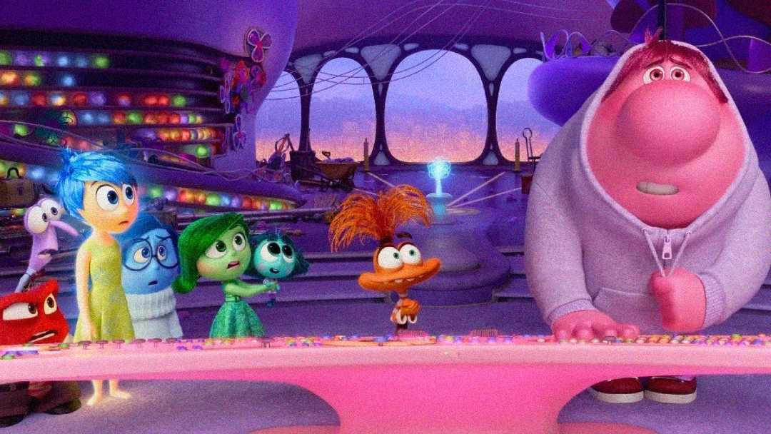 Animated characters from "Inside Out"—Joy, Sadness, Disgust, Fear, and Anger—stand beside Bing Bong and a quirky orange character in a colorful, futuristic control room filled with glowing panels.