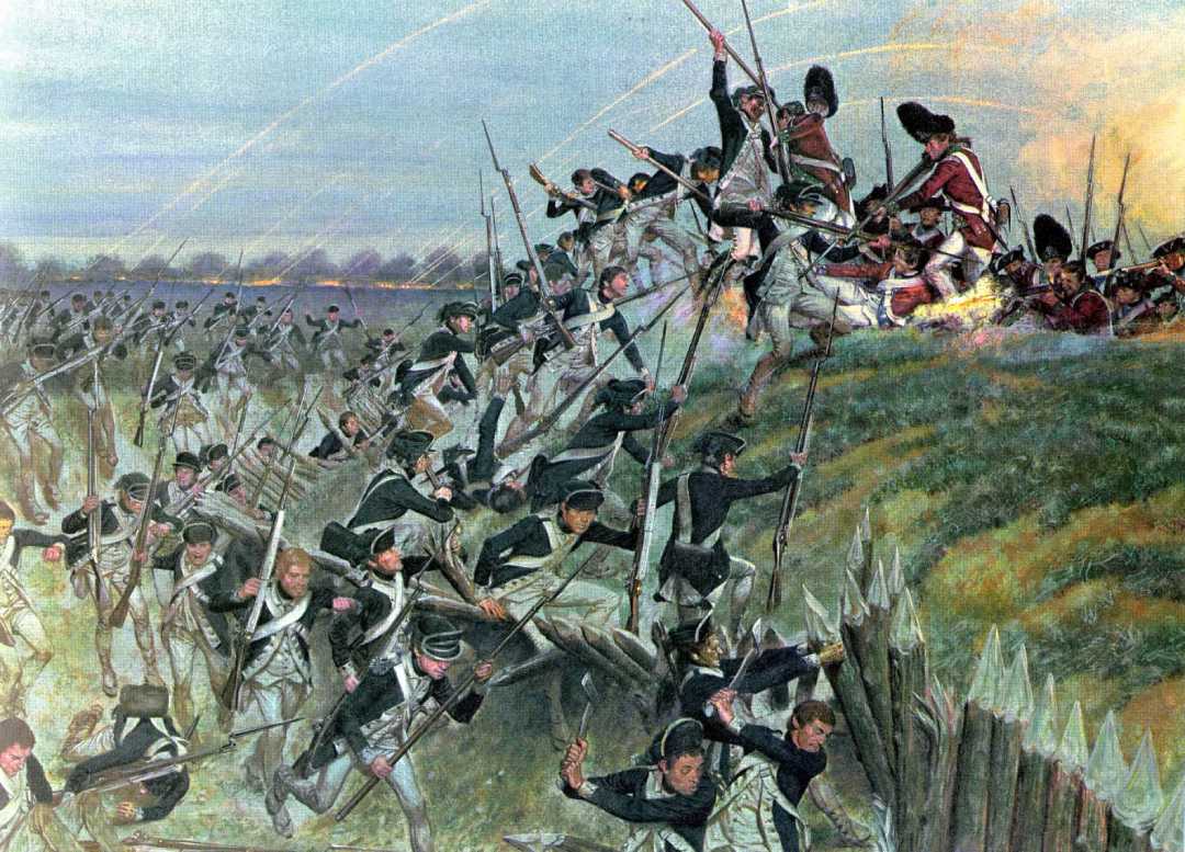 Soldiers in dark uniforms charge up a grassy hill with bayonets raised, attacking defenders in red coats who are firing from behind a wooden barricade during a battle. Smoke and explosions fill the background.