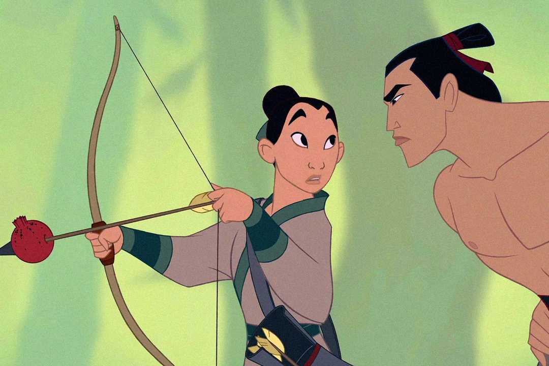 An animated person aims a bow and arrow at a fruit, while another person beside them looks on intently. Both characters have dark hair tied back and are dressed in traditional clothing.