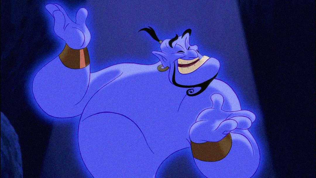 A smiling blue cartoon genie with gold wristbands gestures with open hands, standing in a spotlight against a dark background.