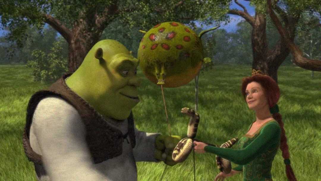 Shrek gives Princess Fiona a balloon made from a blown-up animal part, while Fiona holds a twisted snake balloon, standing together in a green meadow with trees in the background.