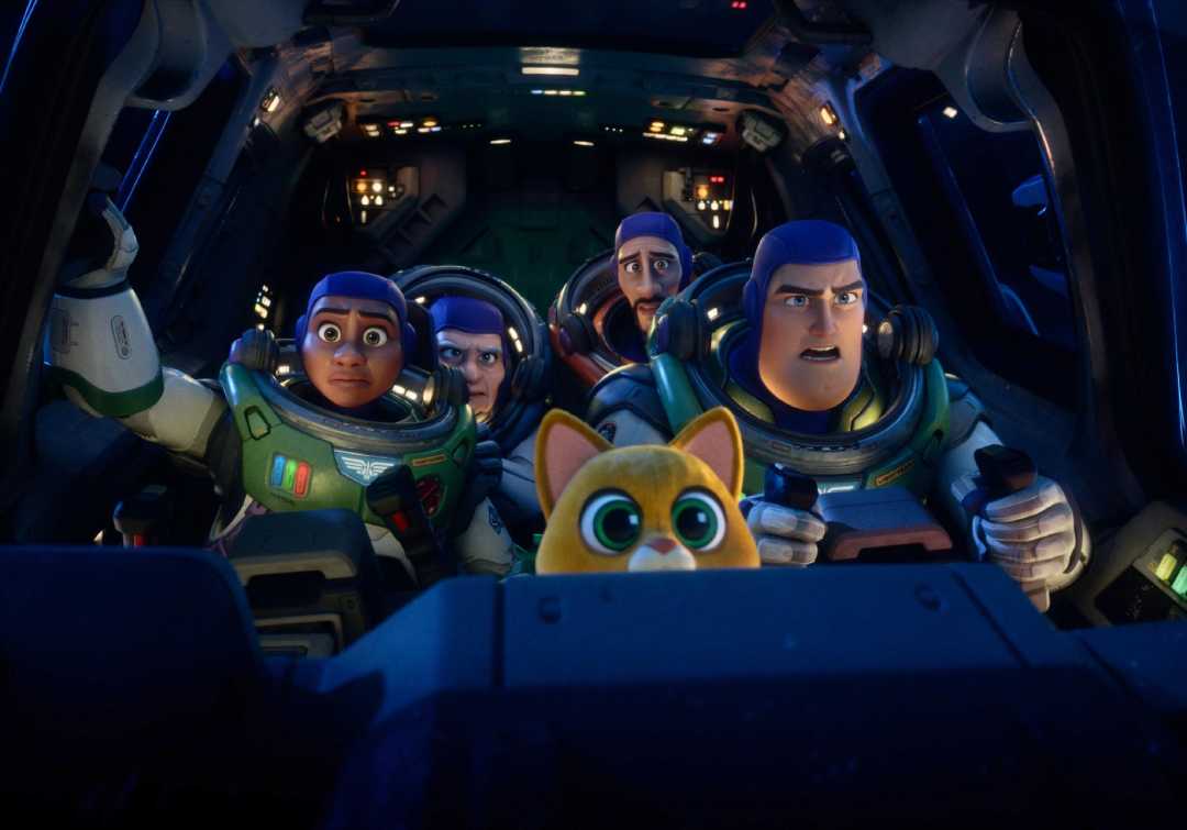 Four animated astronauts and a small orange robot cat sit in a spaceship cockpit, looking ahead with serious and focused expressions, surrounded by glowing controls and panels.